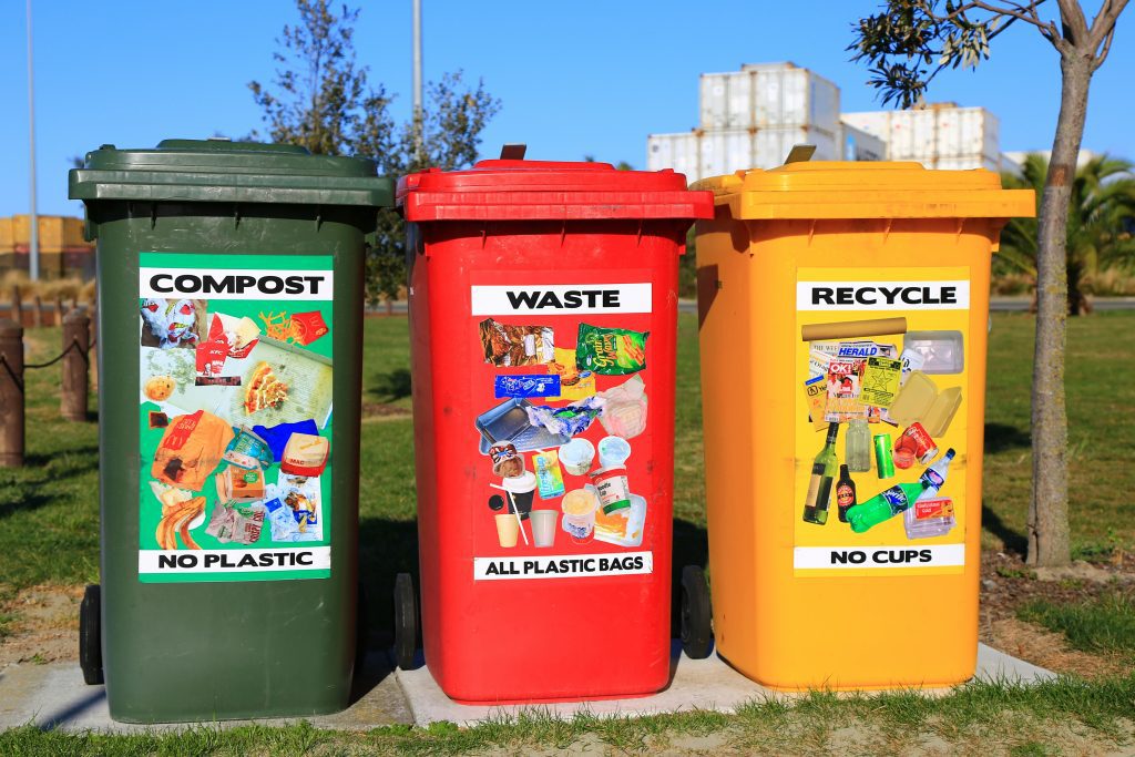 Signs and trash bins urging locals and tourists alike to Reduce, Reuse, and Recycle. Source: Unsplash