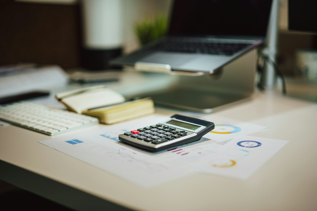 Desk top with financial documents, calculator and computer for tax planning in India